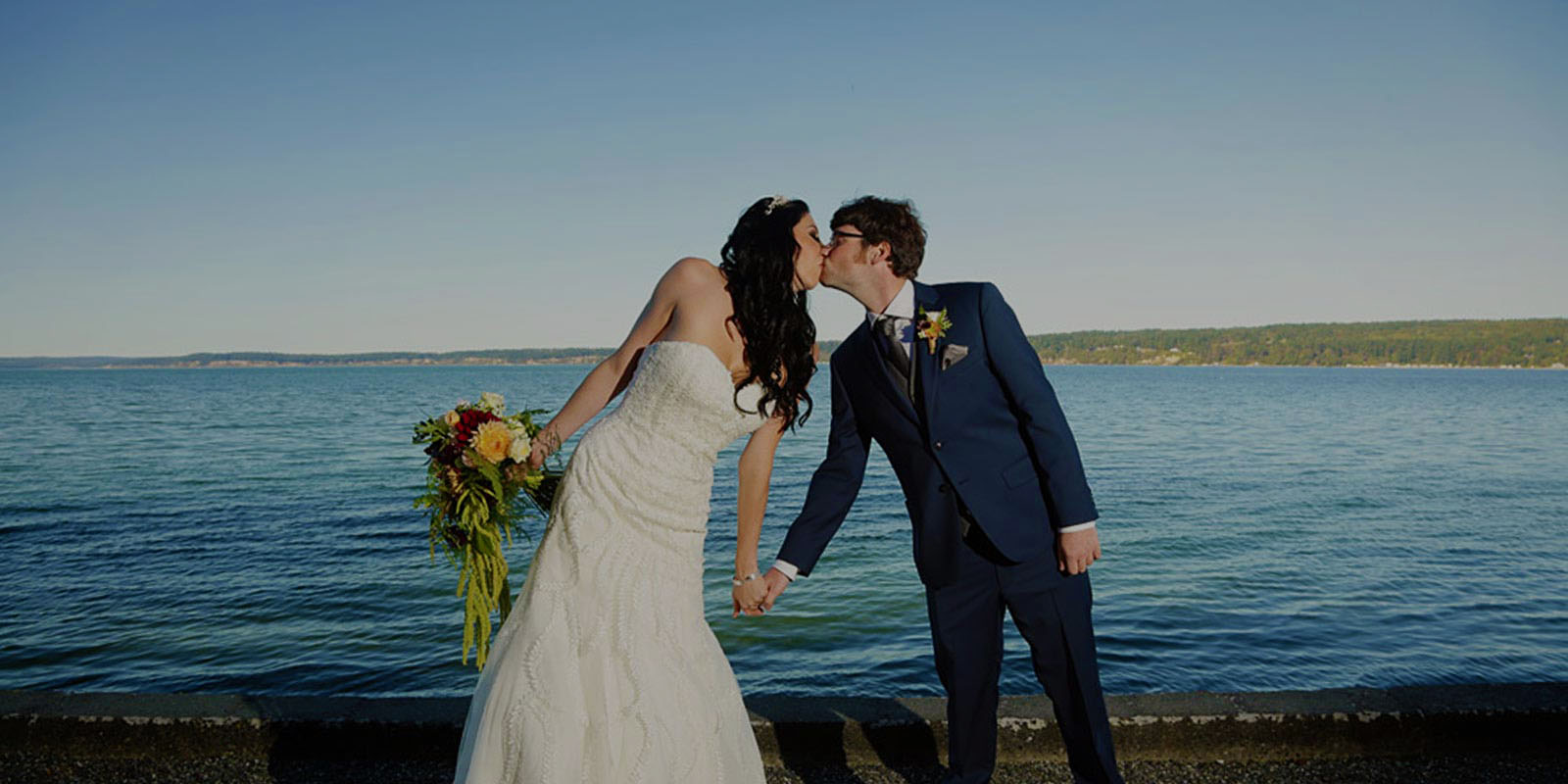 bride & groom kissing at the beach